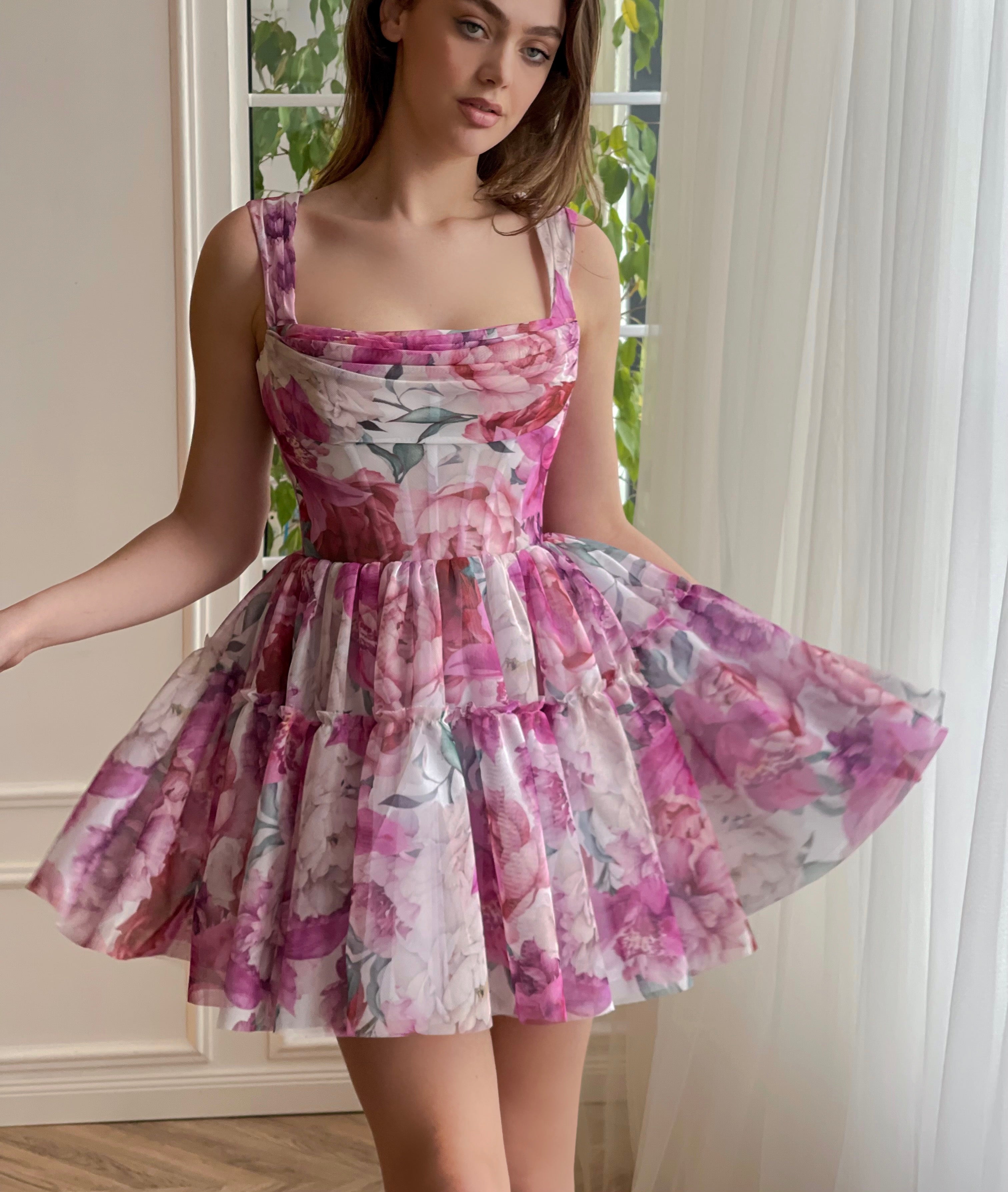 Pink mini dress with printed flowers and straps