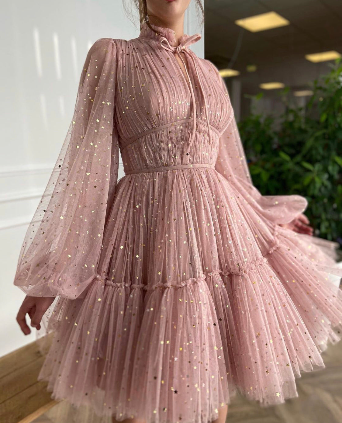 Pink mini dress with long sleeves and starry fabric