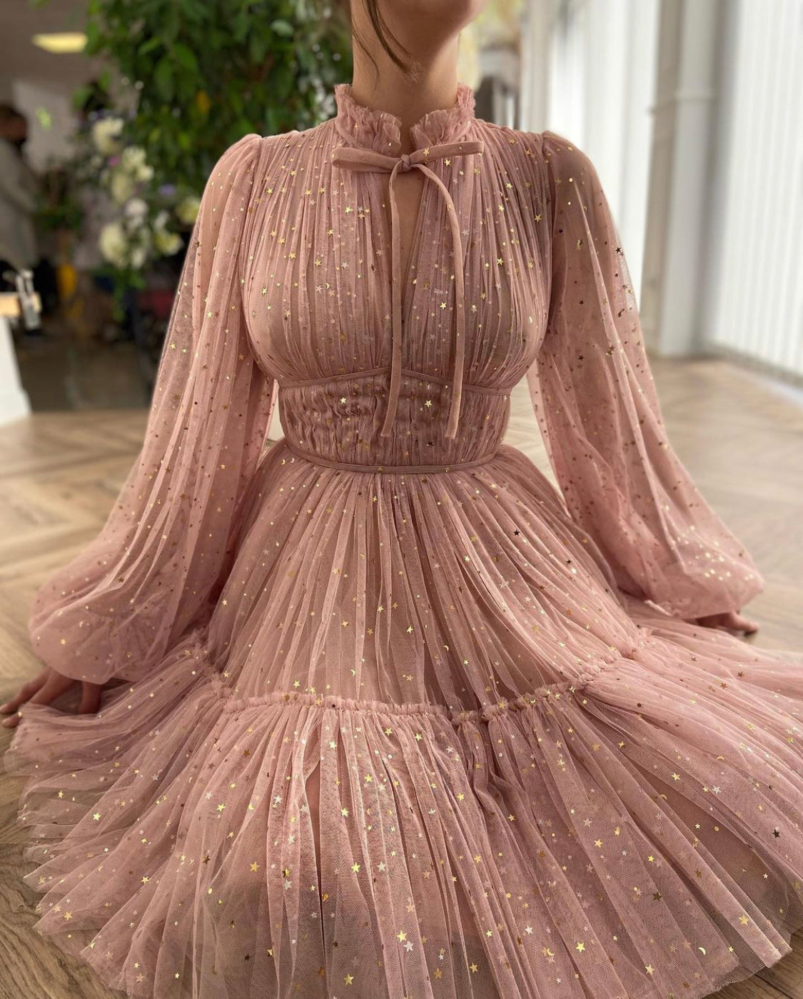 Pink mini dress with long sleeves and starry fabric