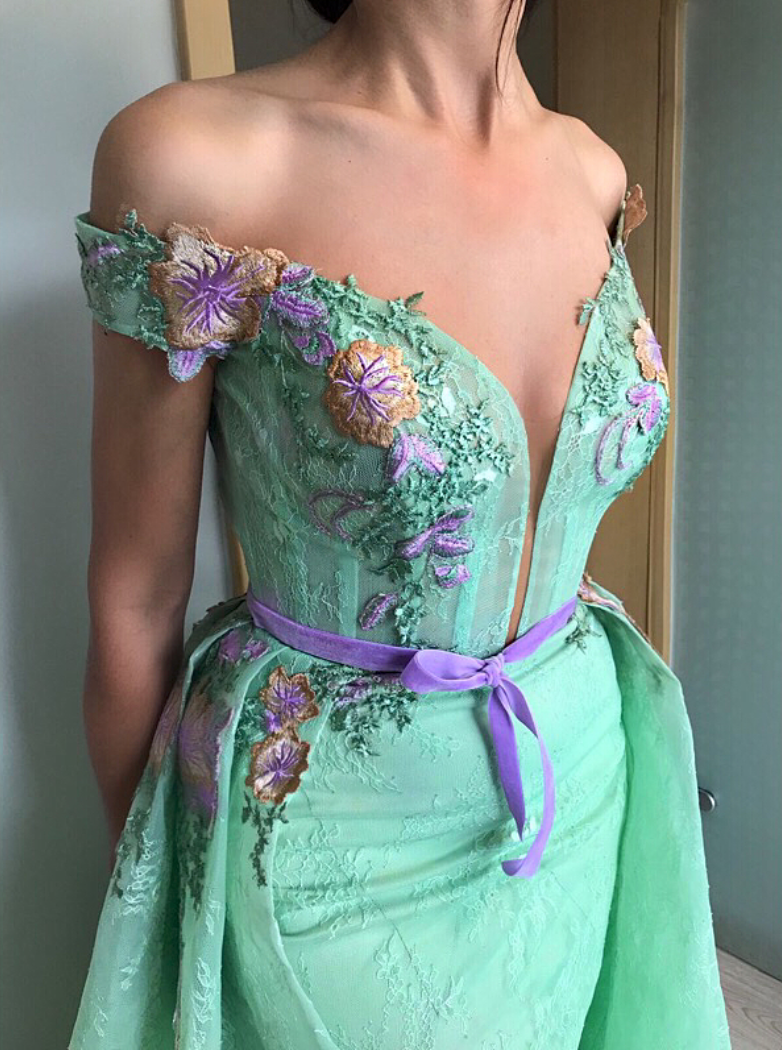 Green overskirt dress with off the shoulder sleeves and embroidery