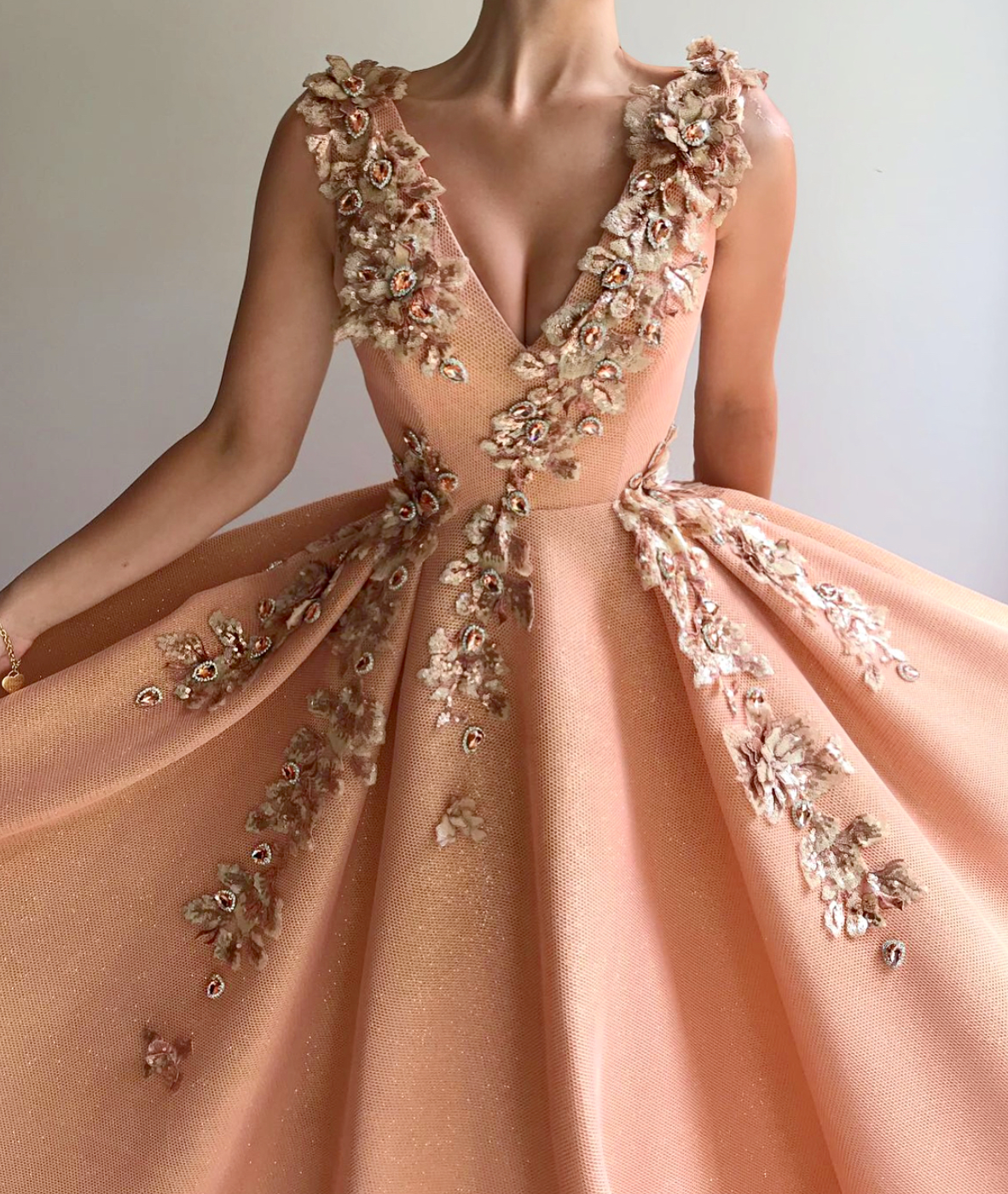 Peach A-Line dress with v-neck, no sleeves and embroidery