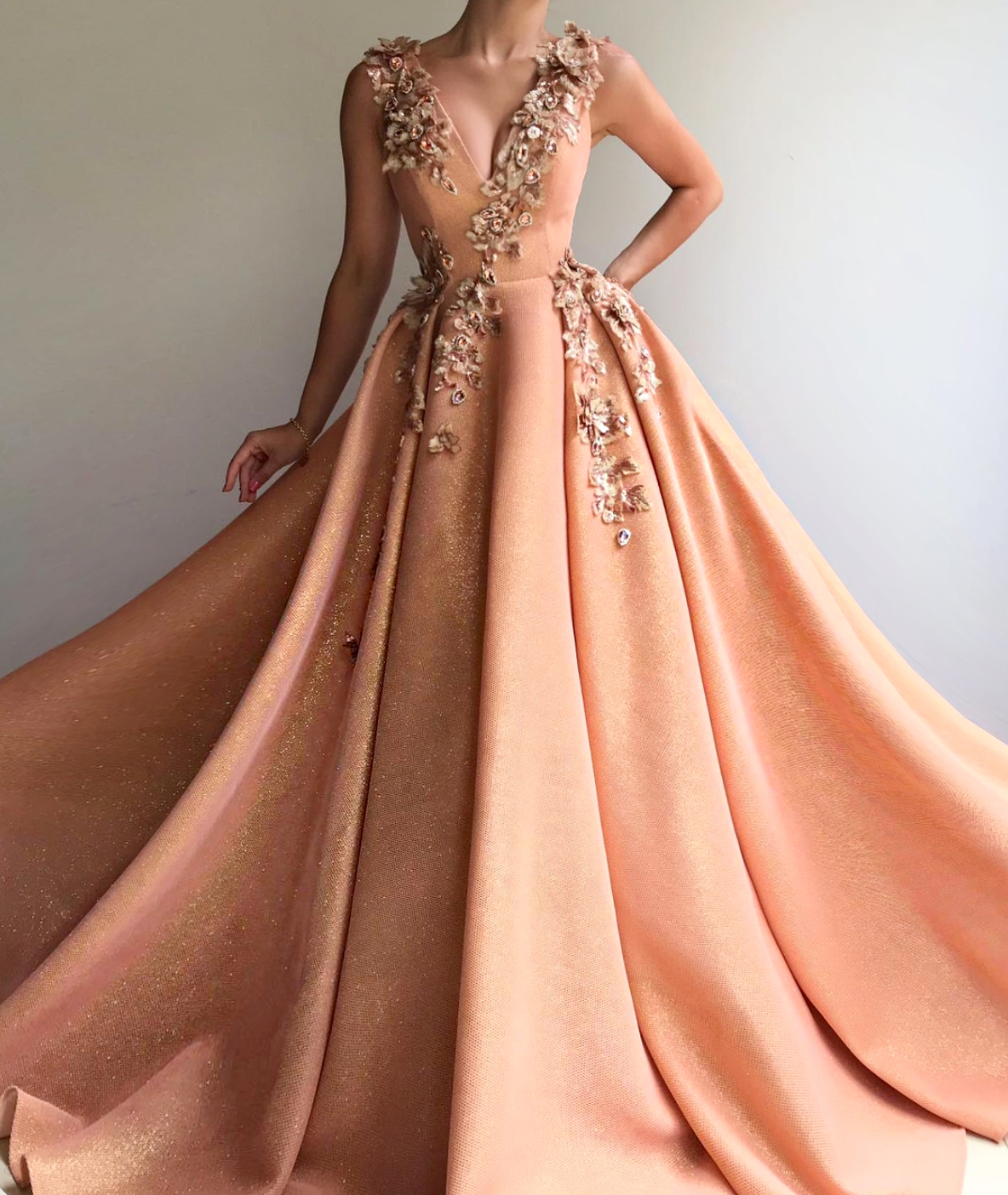 Peach A-Line dress with v-neck, no sleeves and embroidery