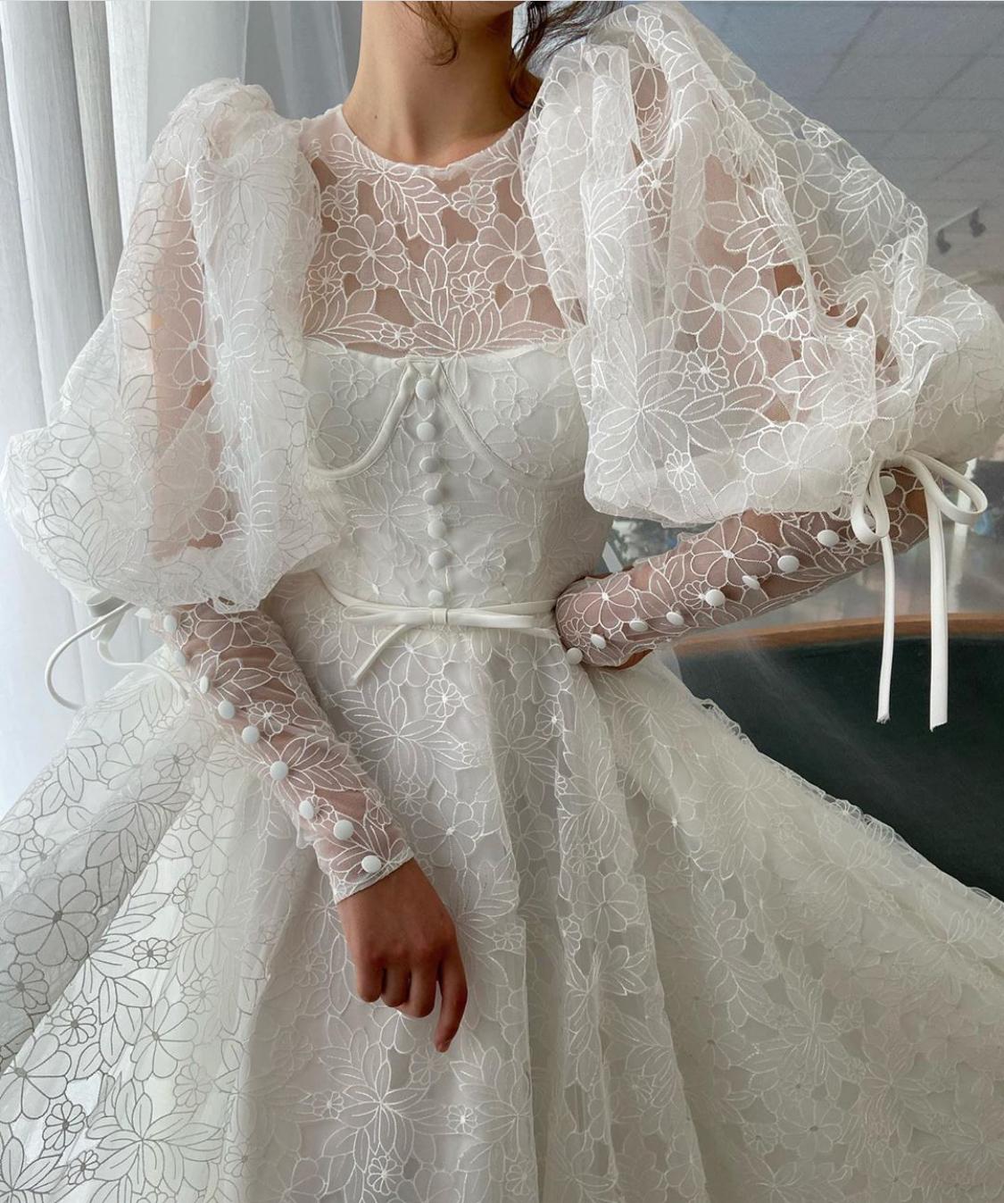 A Line white bridal dress with buttons, flowers and long sleeves