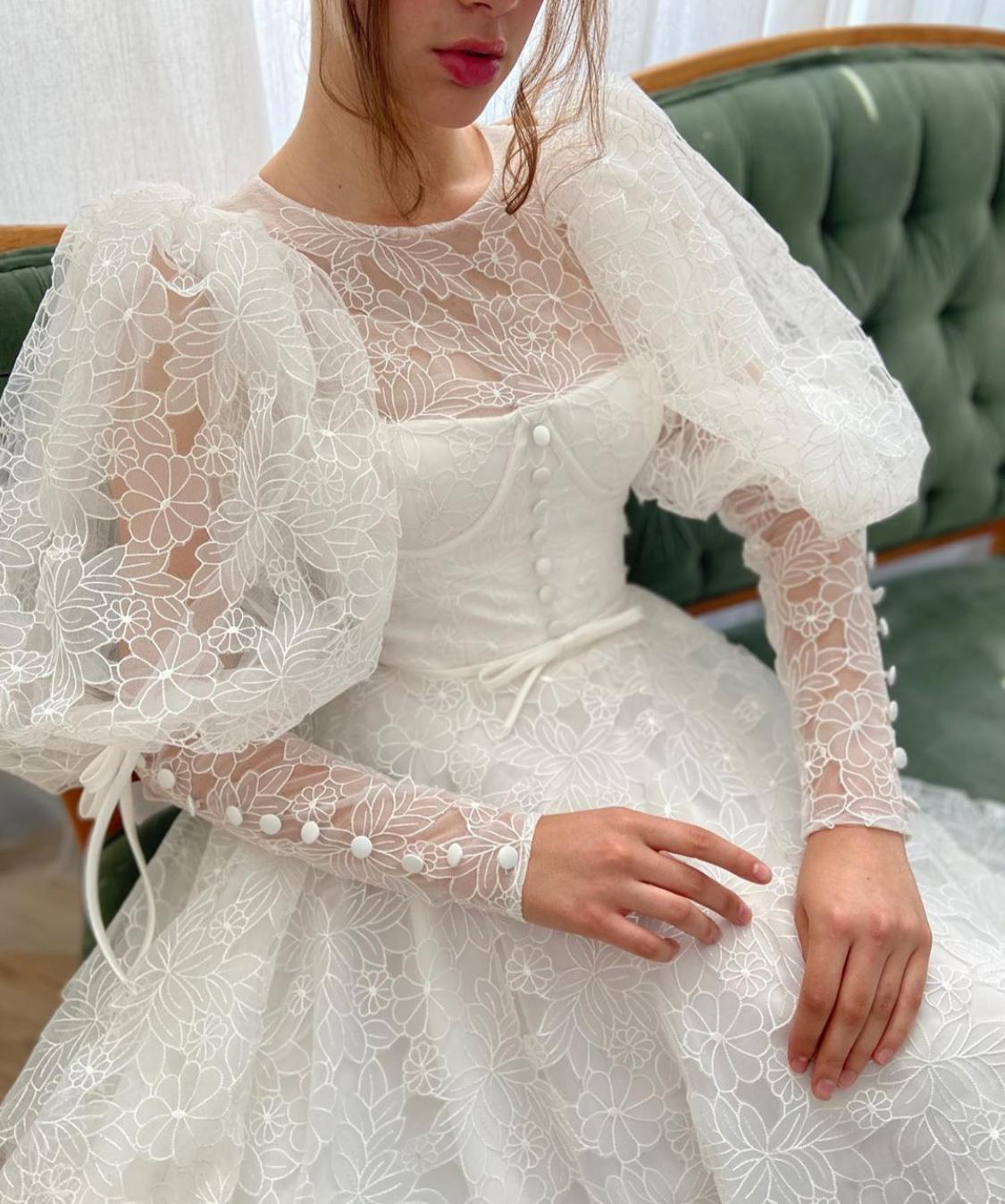 A Line white bridal dress with buttons, flowers and long sleeves