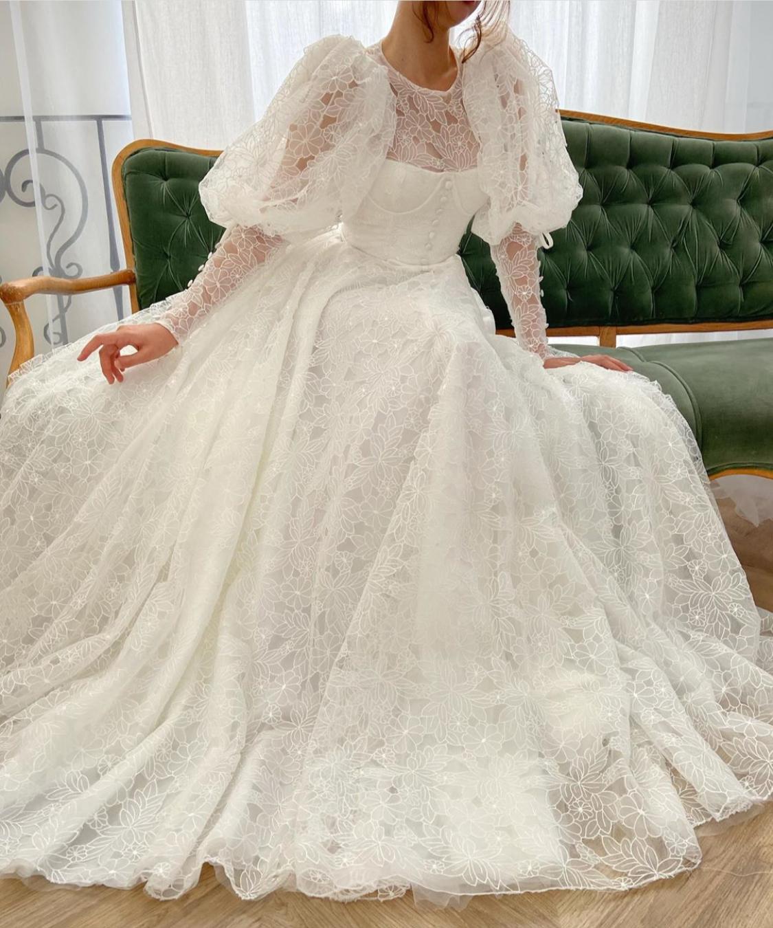 A Line white bridal dress with buttons, flowers and long sleeves
