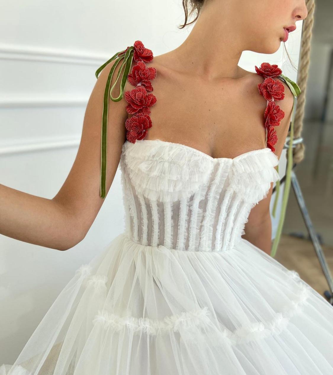 A line white bridal dress with embroidered flowers and spaghetti straps