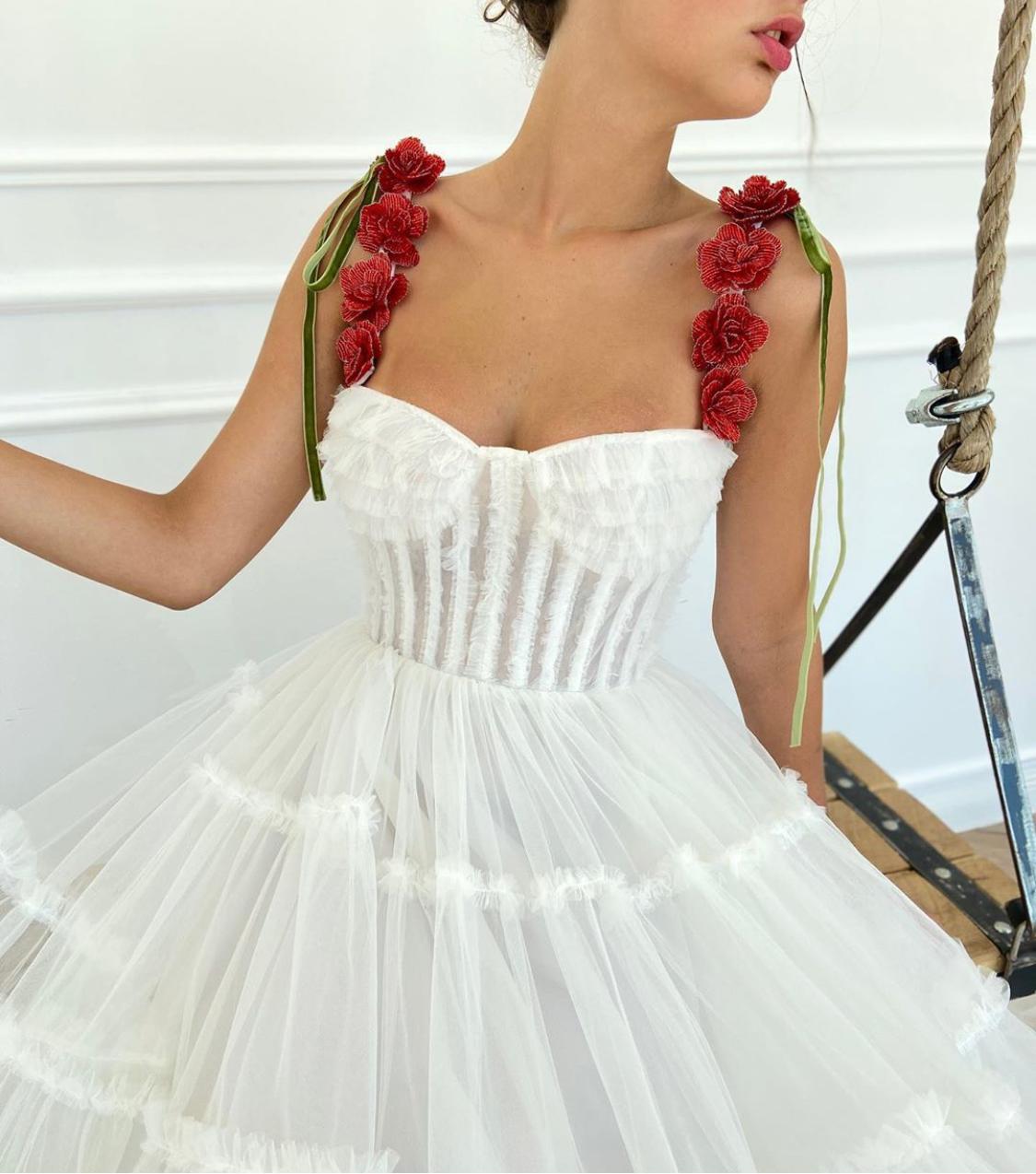 A line white bridal dress with embroidered flowers and spaghetti straps