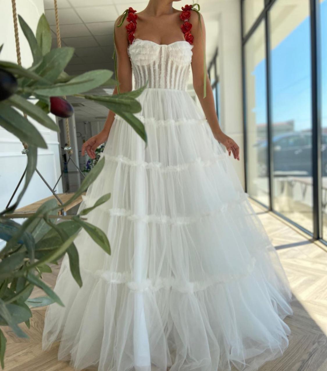 A line white bridal dress with embroidered flowers and spaghetti straps