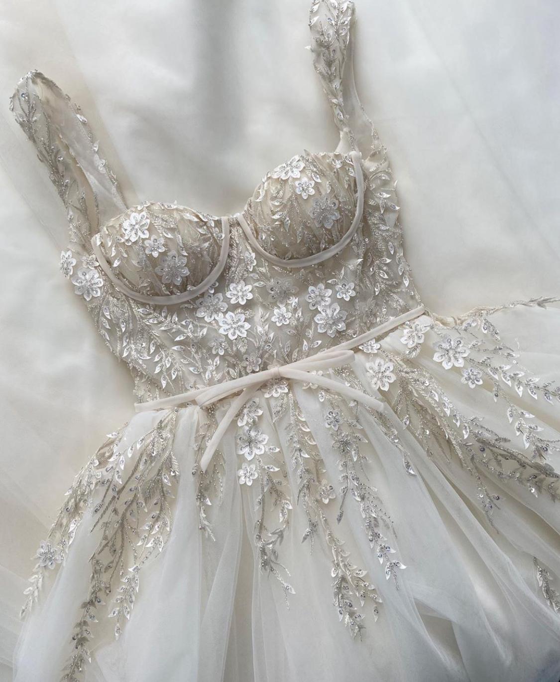 A line white bridal dress with embroidered flowers, straps and train