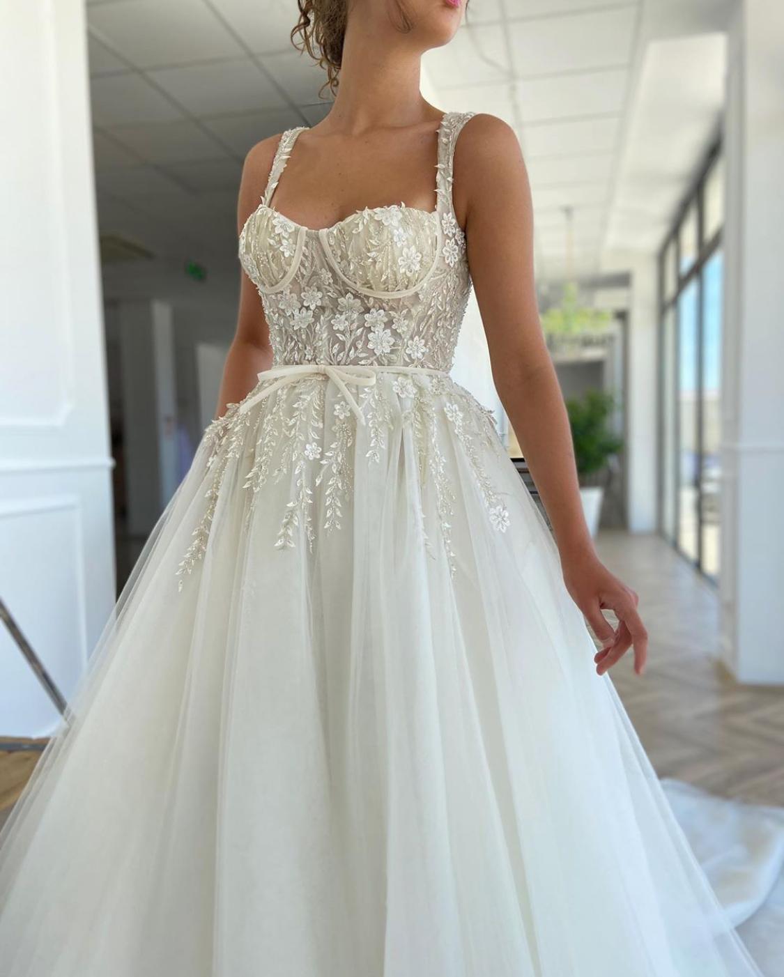 A line white bridal dress with embroidered flowers, straps and train