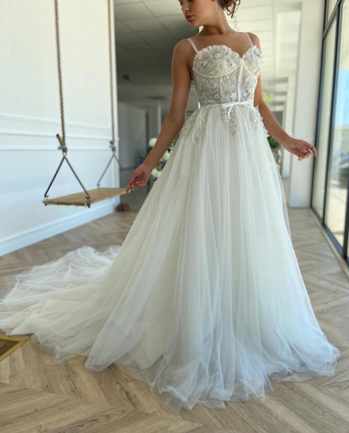 A line white bridal dress with embroidered flowers and straps
