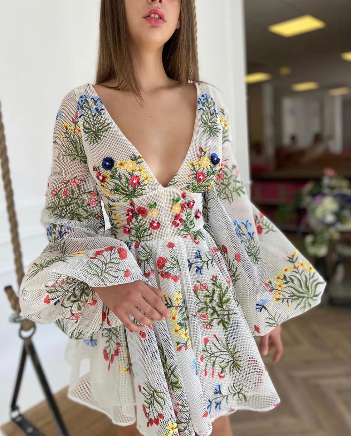 White mini dress with v-neck, long sleeves and embroidery