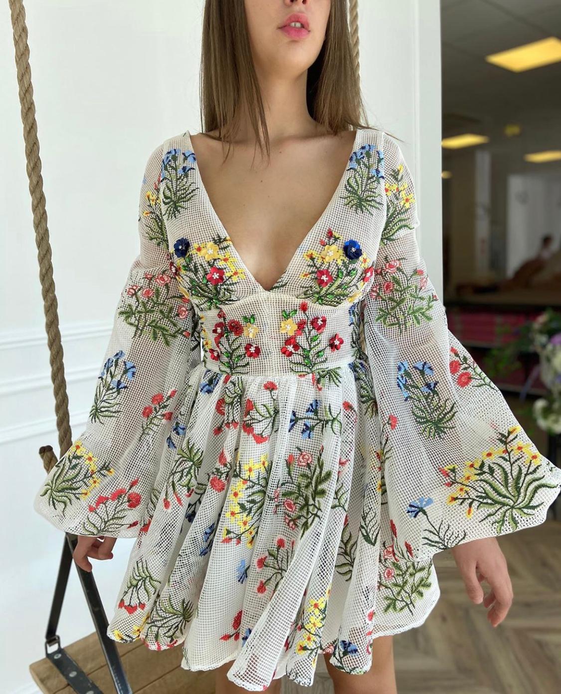 White mini dress with v-neck, long sleeves and embroidery