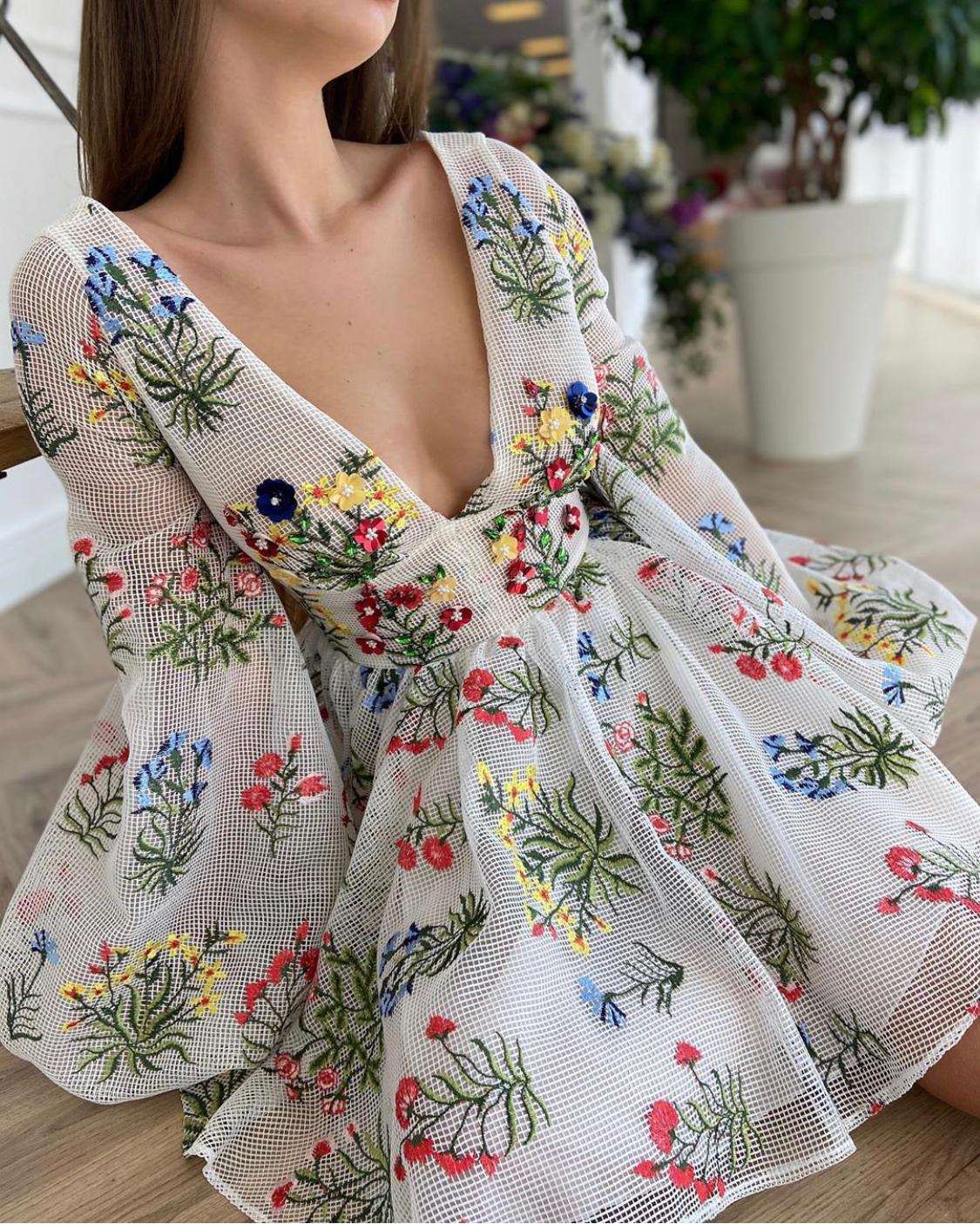 White mini dress with v-neck, long sleeves and embroidery