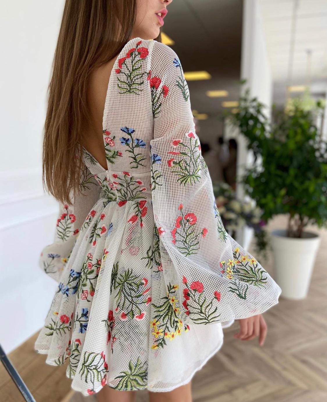 White mini dress with v-neck, long sleeves and embroidery
