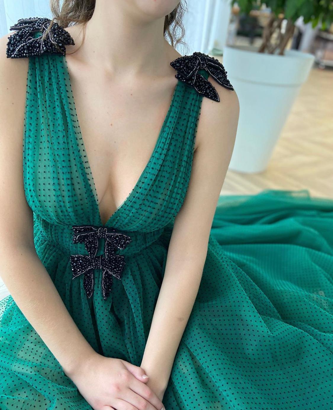 Green A-Line dress with v-neck, no sleeves and embroidery