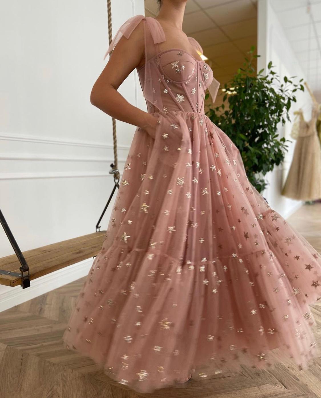 Pink midi dress with bow straps and starry fabric