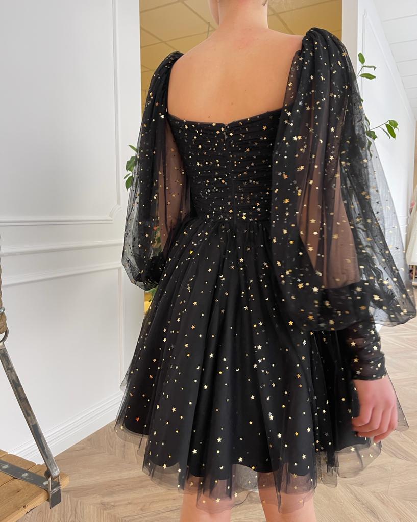 Black mini dress with long sleeves and starry fabric