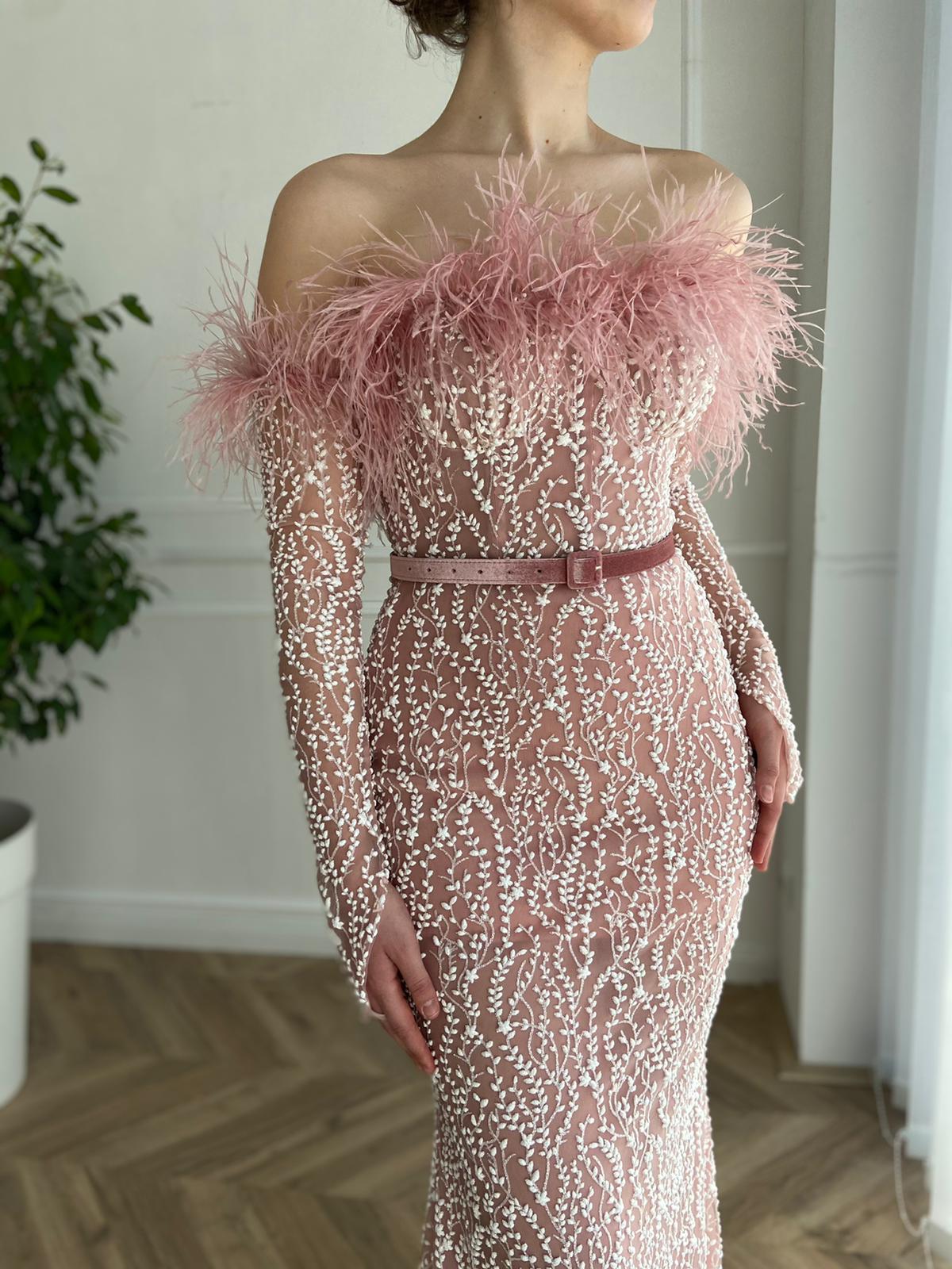 Pink mermaid dress with long off the shoulder sleeves, belt and feathers