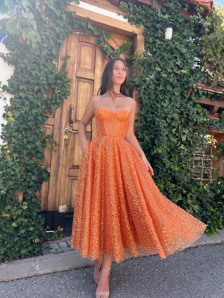 Orange midi dress with cape and no sleeves