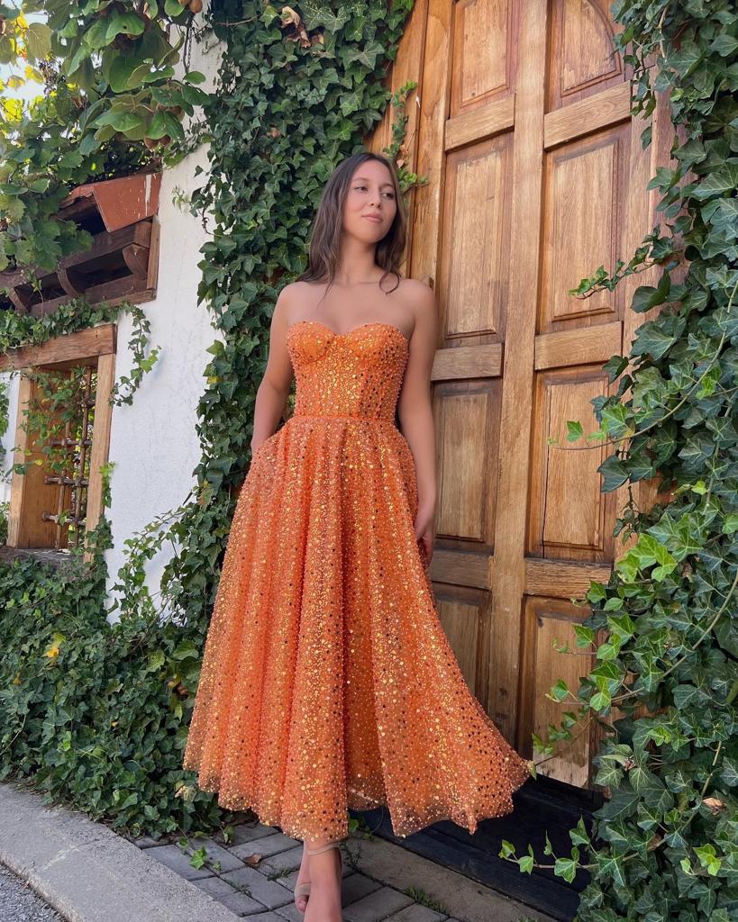 Orange midi dress with cape and no sleeves