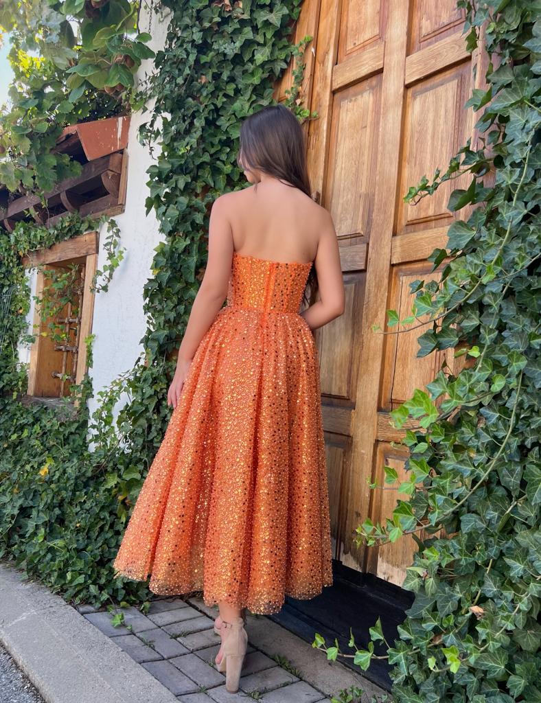 Orange midi dress with cape and no sleeves