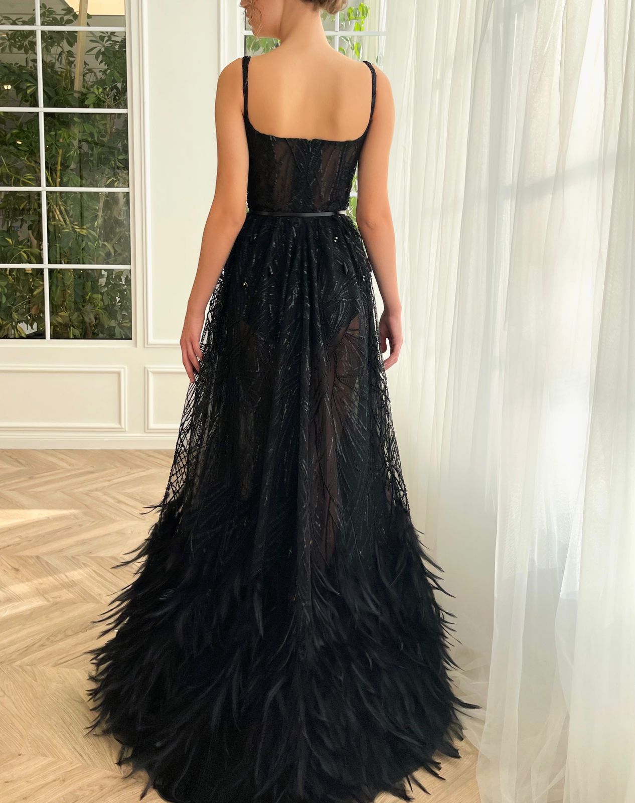 Black A-Line dress with spaghetti straps and feathers