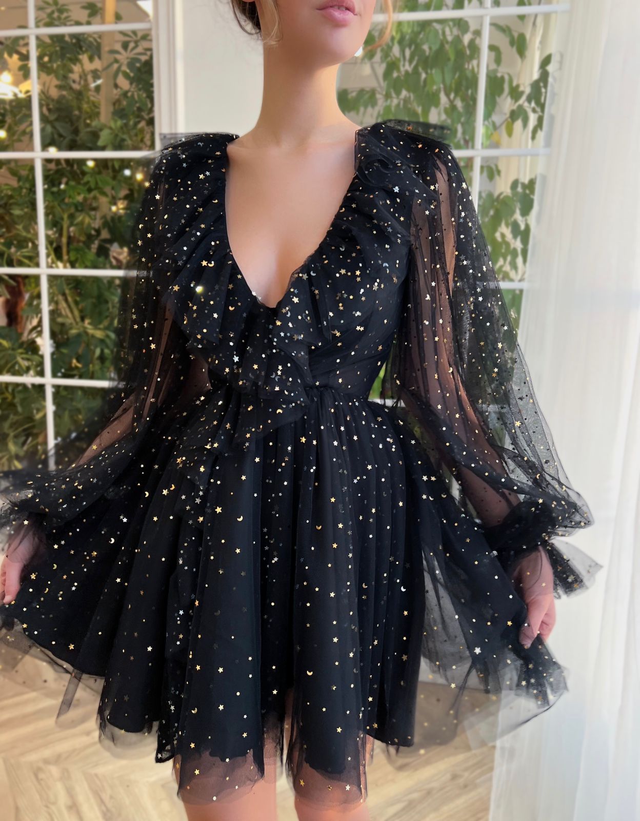 Black mini dress with long sleeves and starry fabric