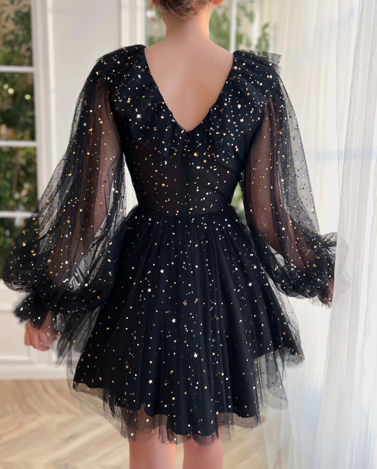 Black mini dress with long sleeves and starry fabric