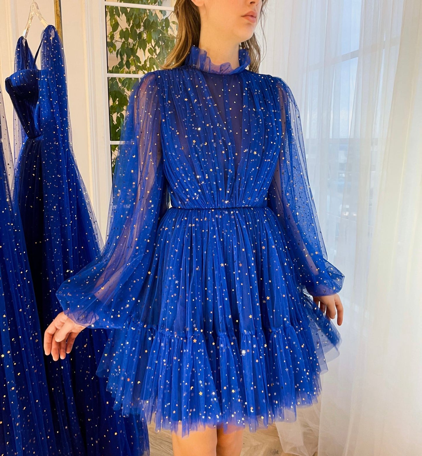 Blue mini dress with long sleeves and starry fabric