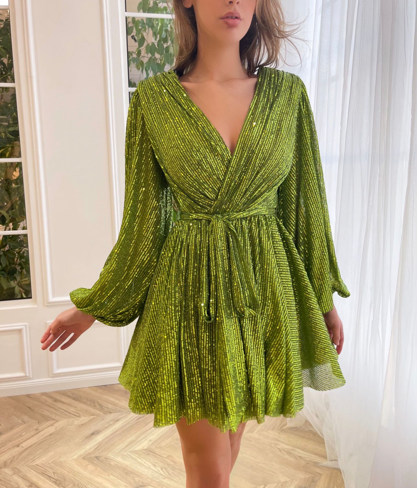 Green mini dress with sequins, v-neck and long sleeves