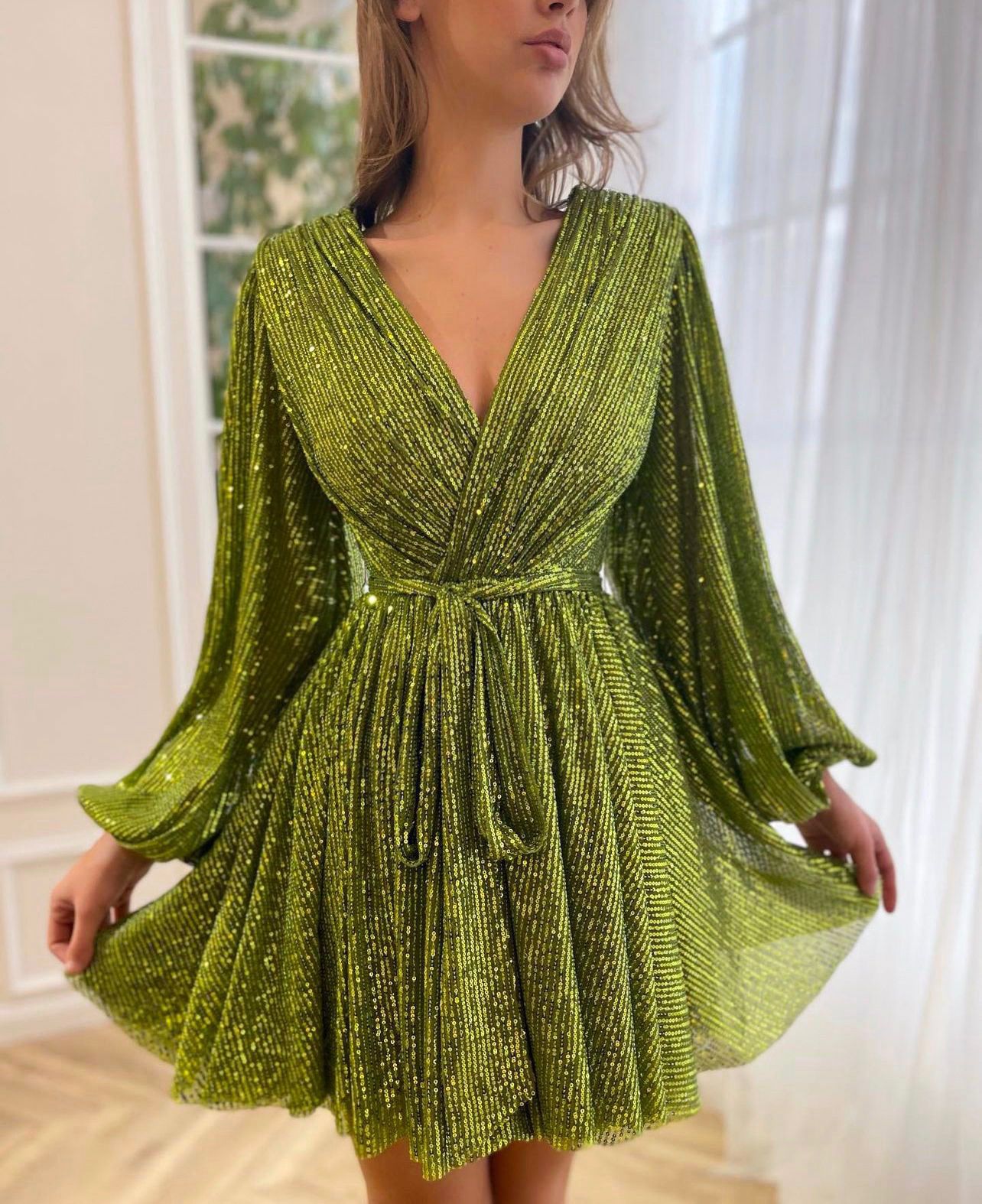 Green mini dress with sequins, v-neck and long sleeves