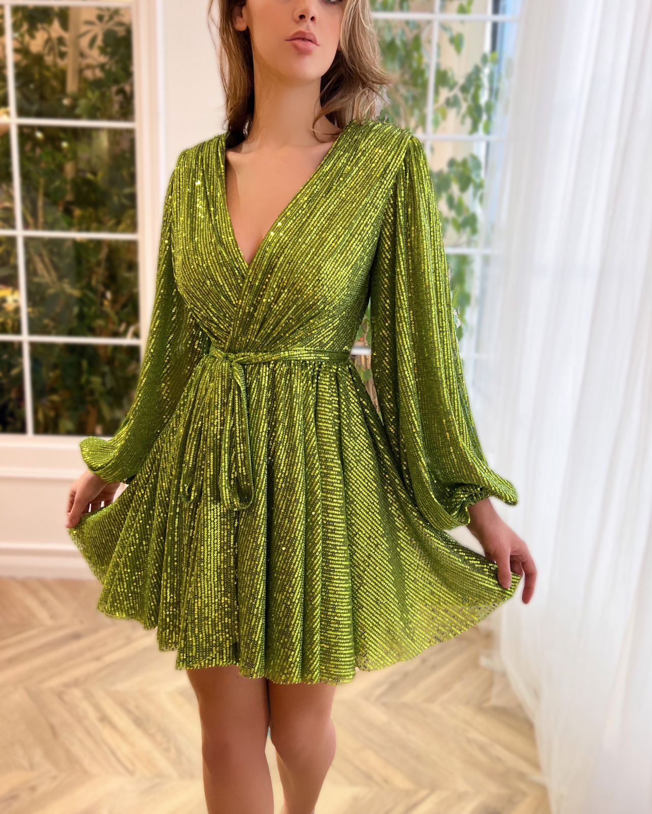Green mini dress with sequins, v-neck and long sleeves