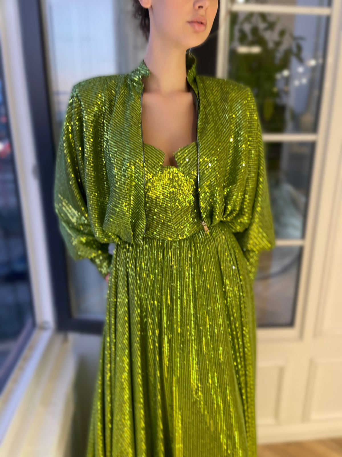 Green two piece dress with long sleeves and sequins