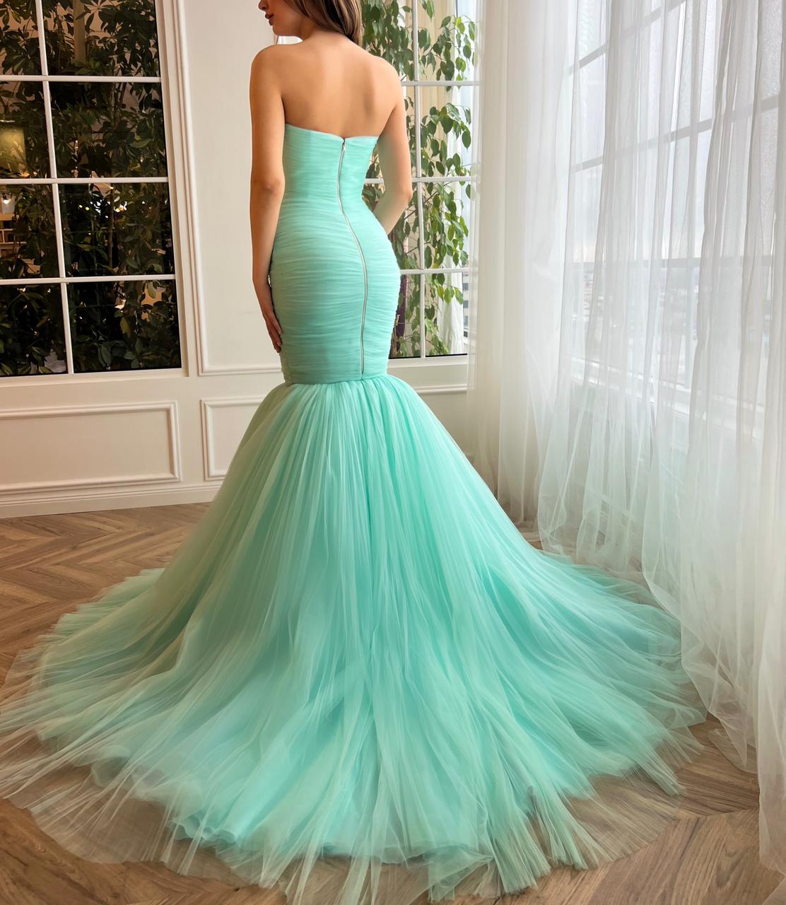 Turquoise mermaid dress with no sleeves and train
