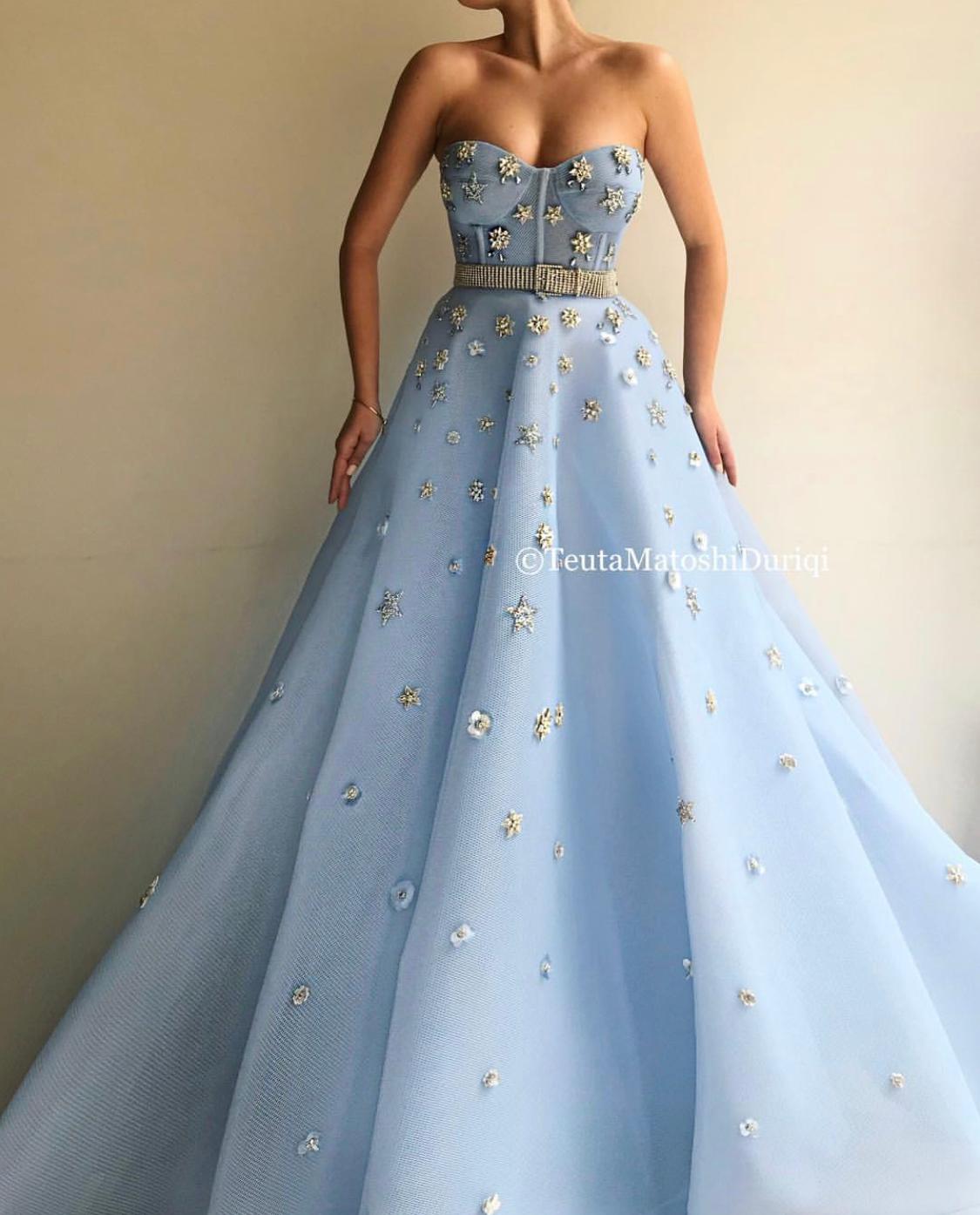 Blue A-Line dress with no sleeves, belt and starry fabric