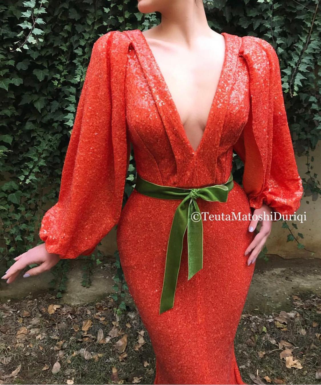 Orange mermaid dress with v-neck and long sleeves