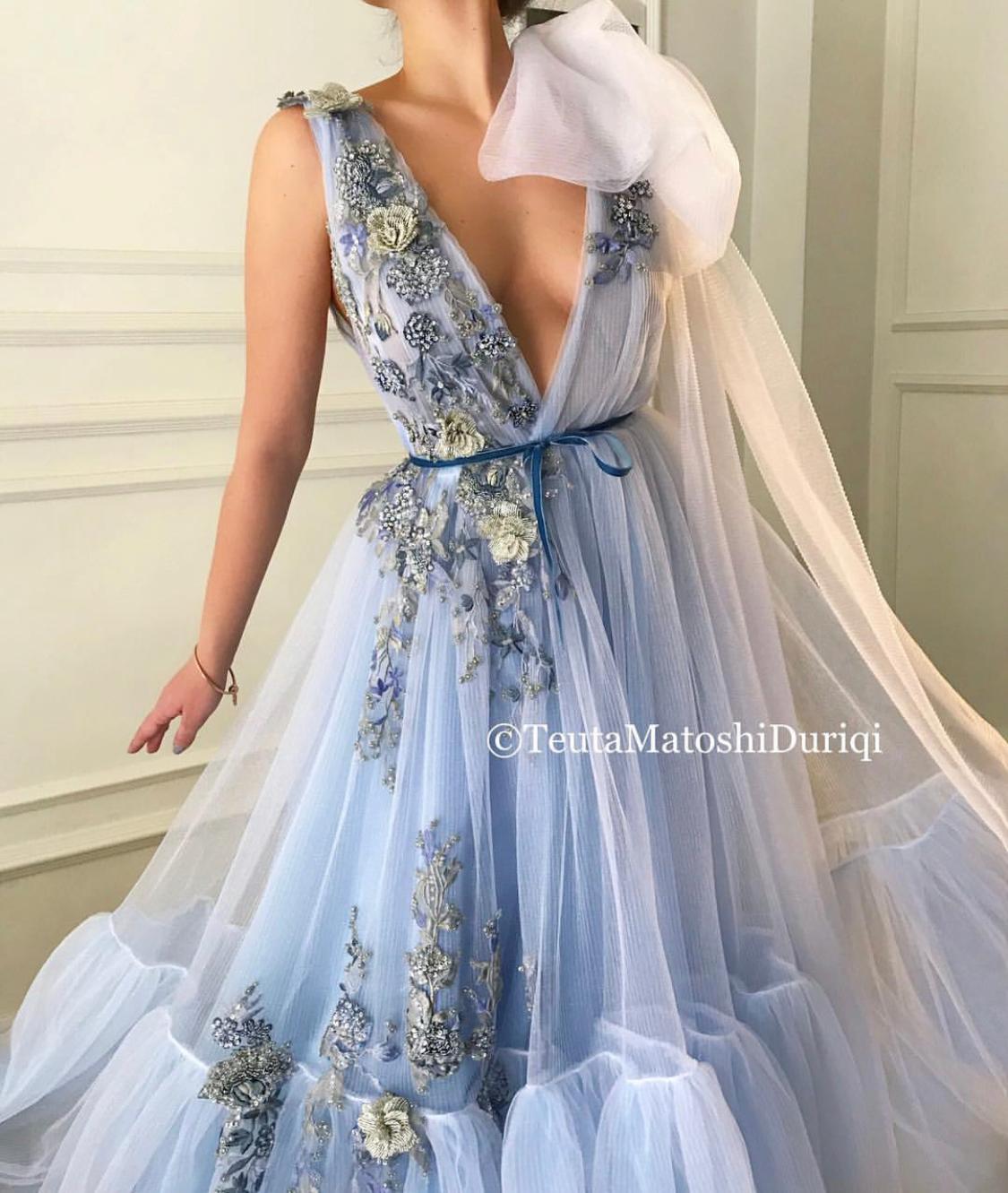 Blue A-Line dress with v-neck, one cape sleeve and embroidery