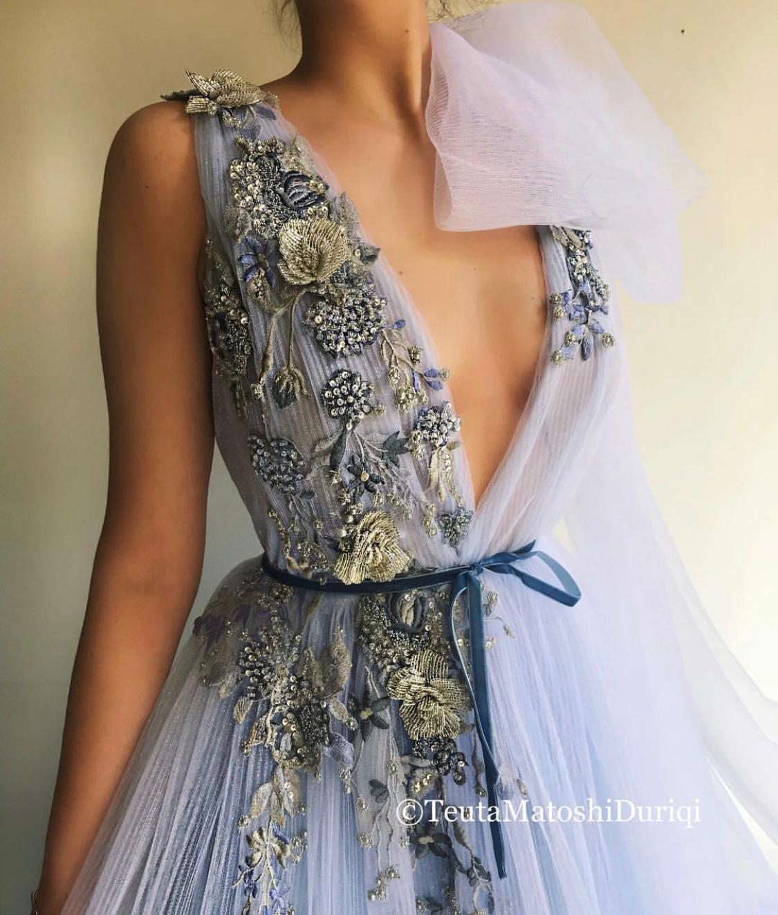 Blue A-Line dress with v-neck, one cape sleeve and embroidery