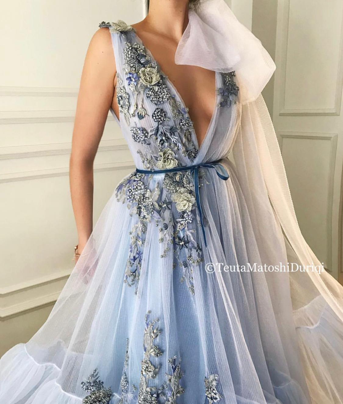 Blue A-Line dress with v-neck, one cape sleeve and embroidery