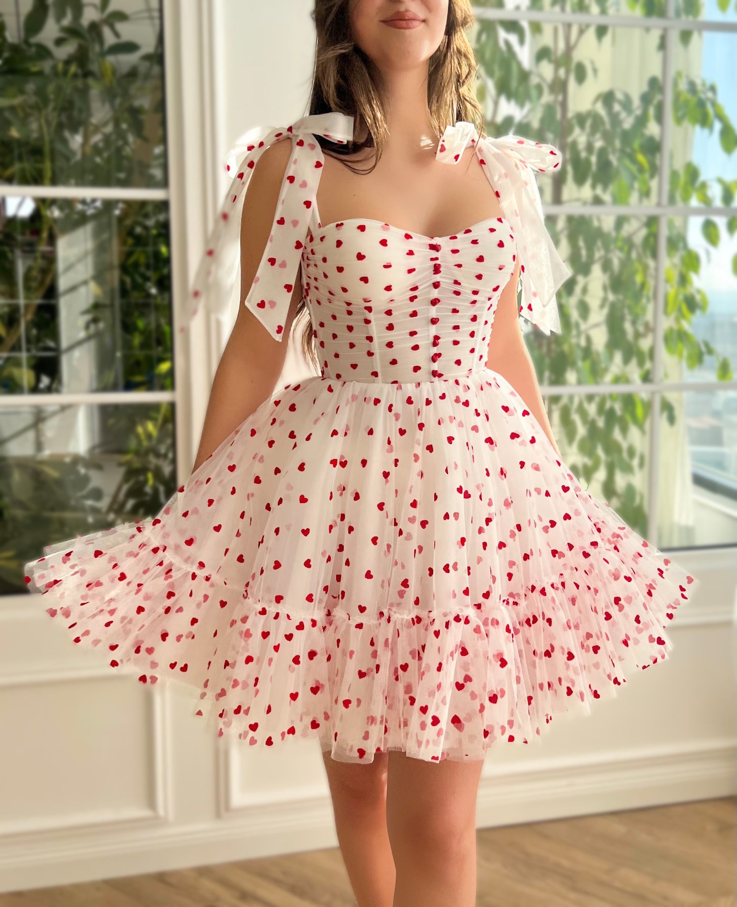 White mini dress with hearty print and bow straps