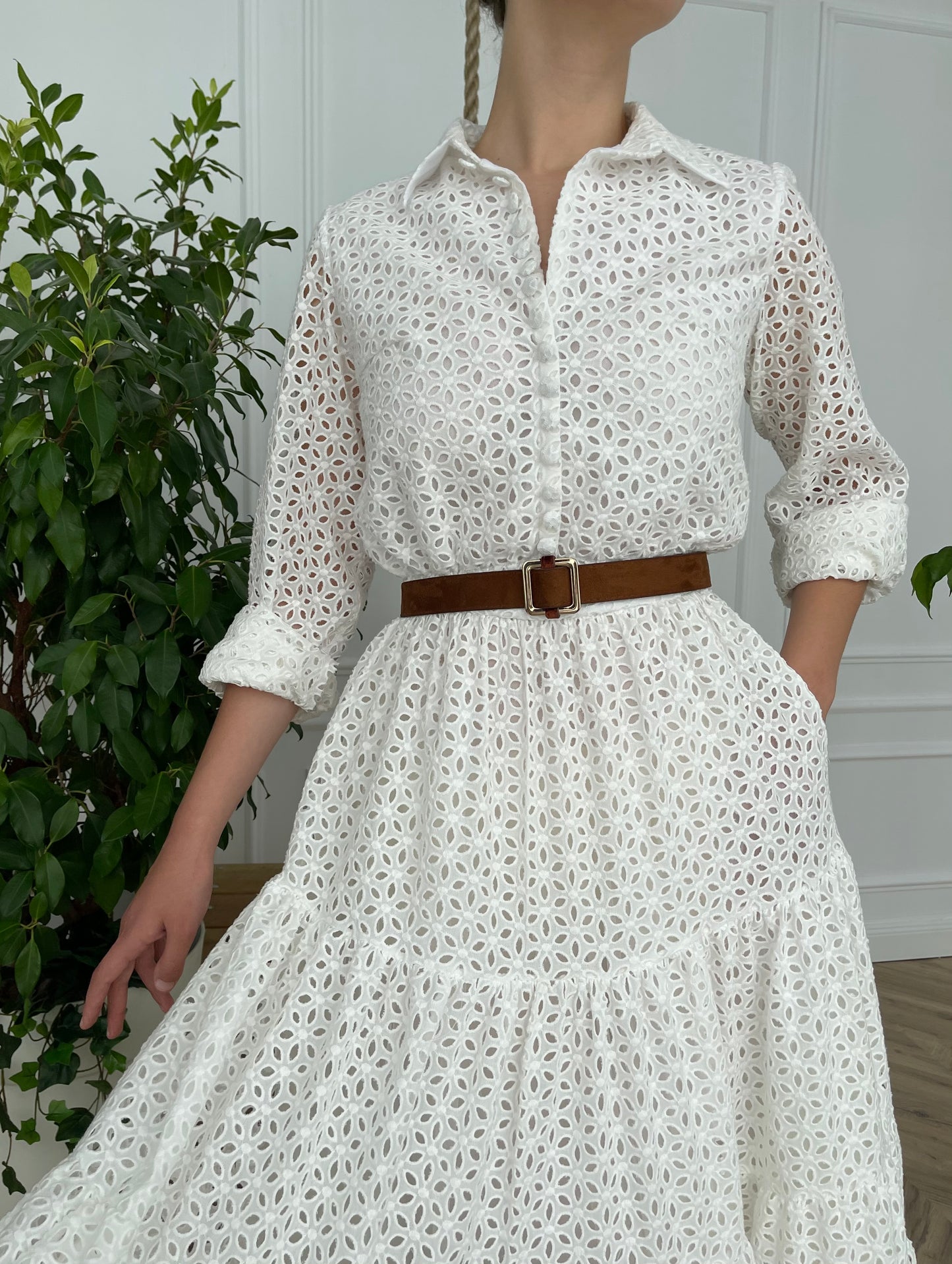 A line white bridal dress with brown belt and long sleeves