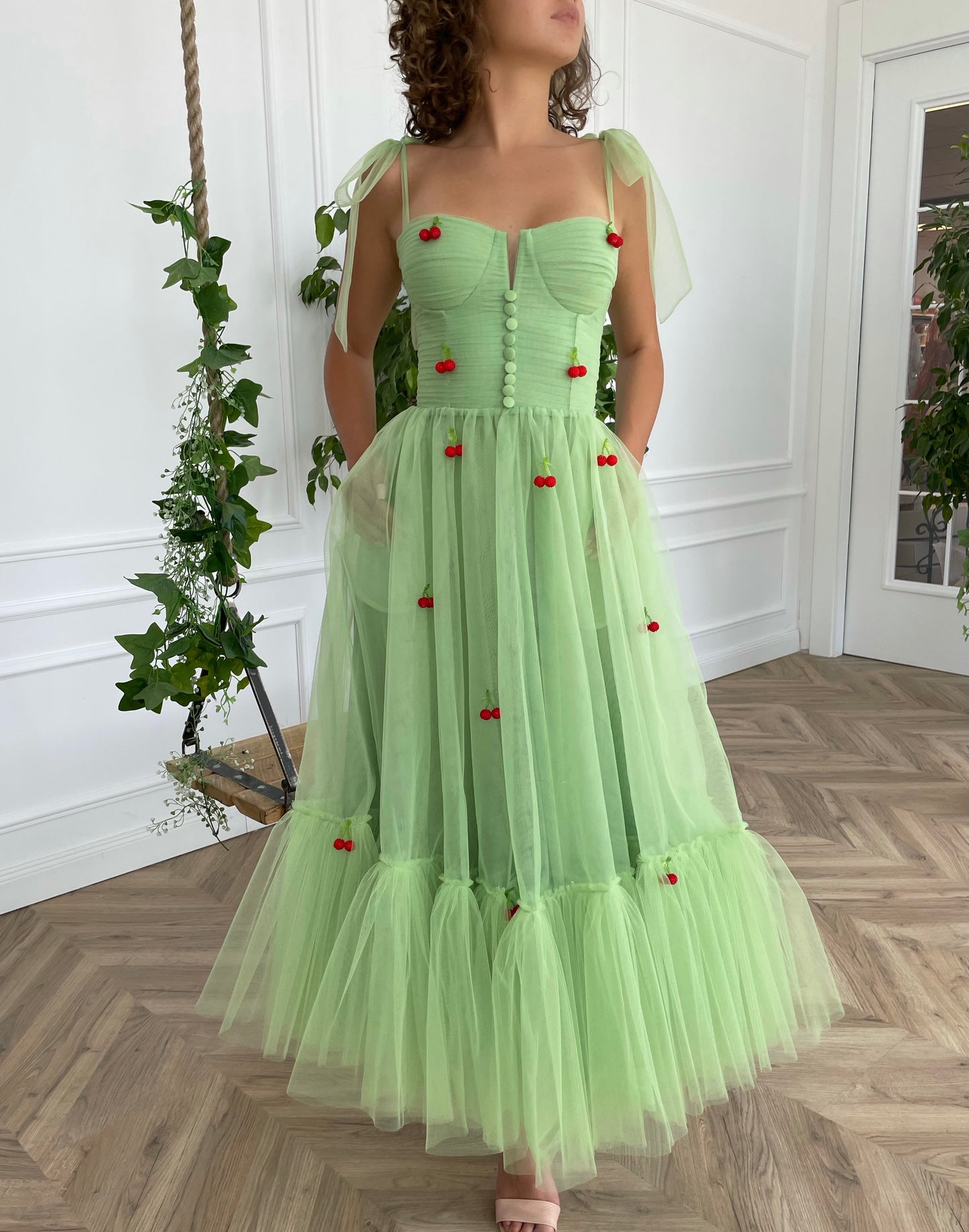 Green midi dress with bow straps and embroidered cherries
