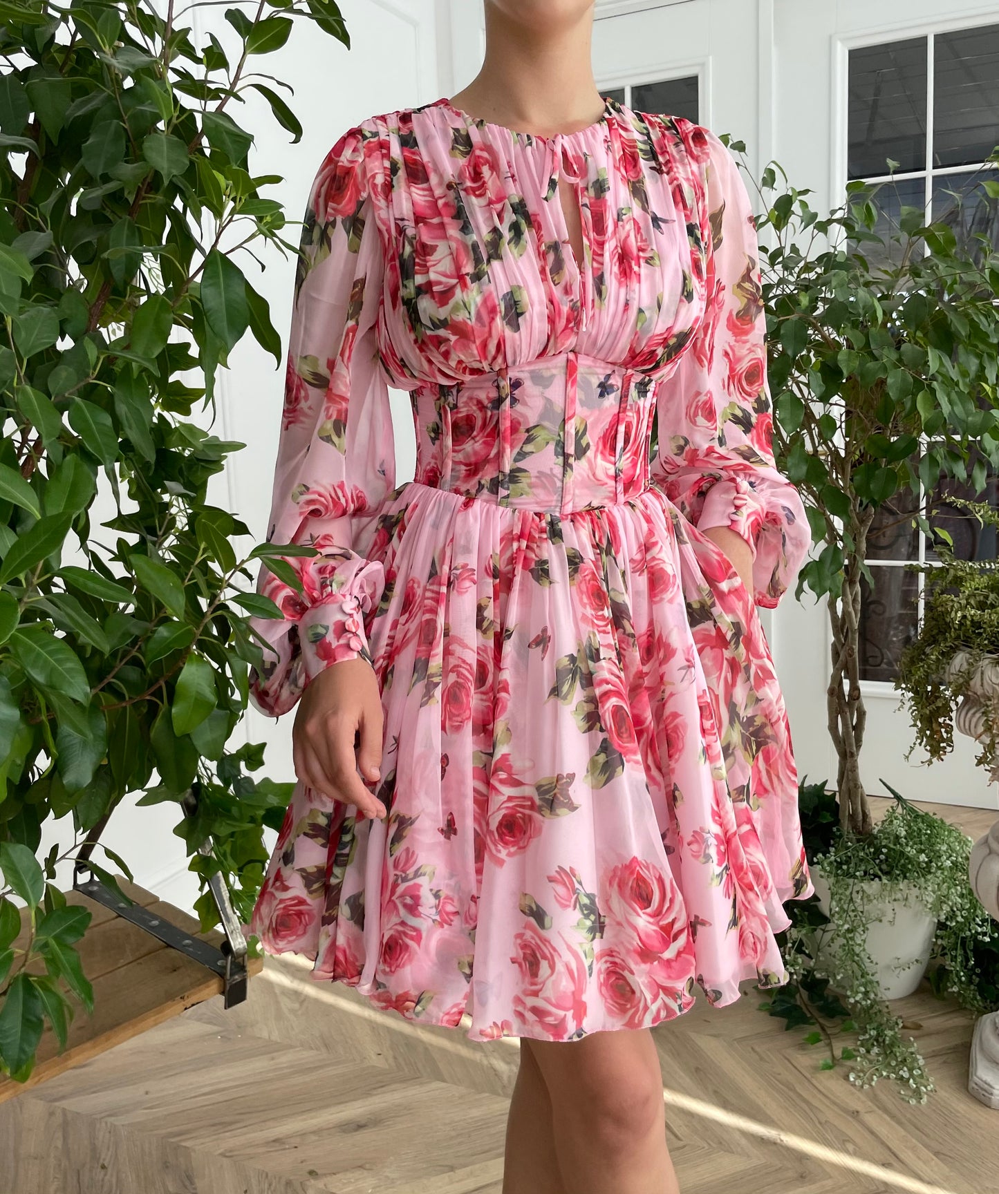 Pink mini dress with long sleeves and printed flowers