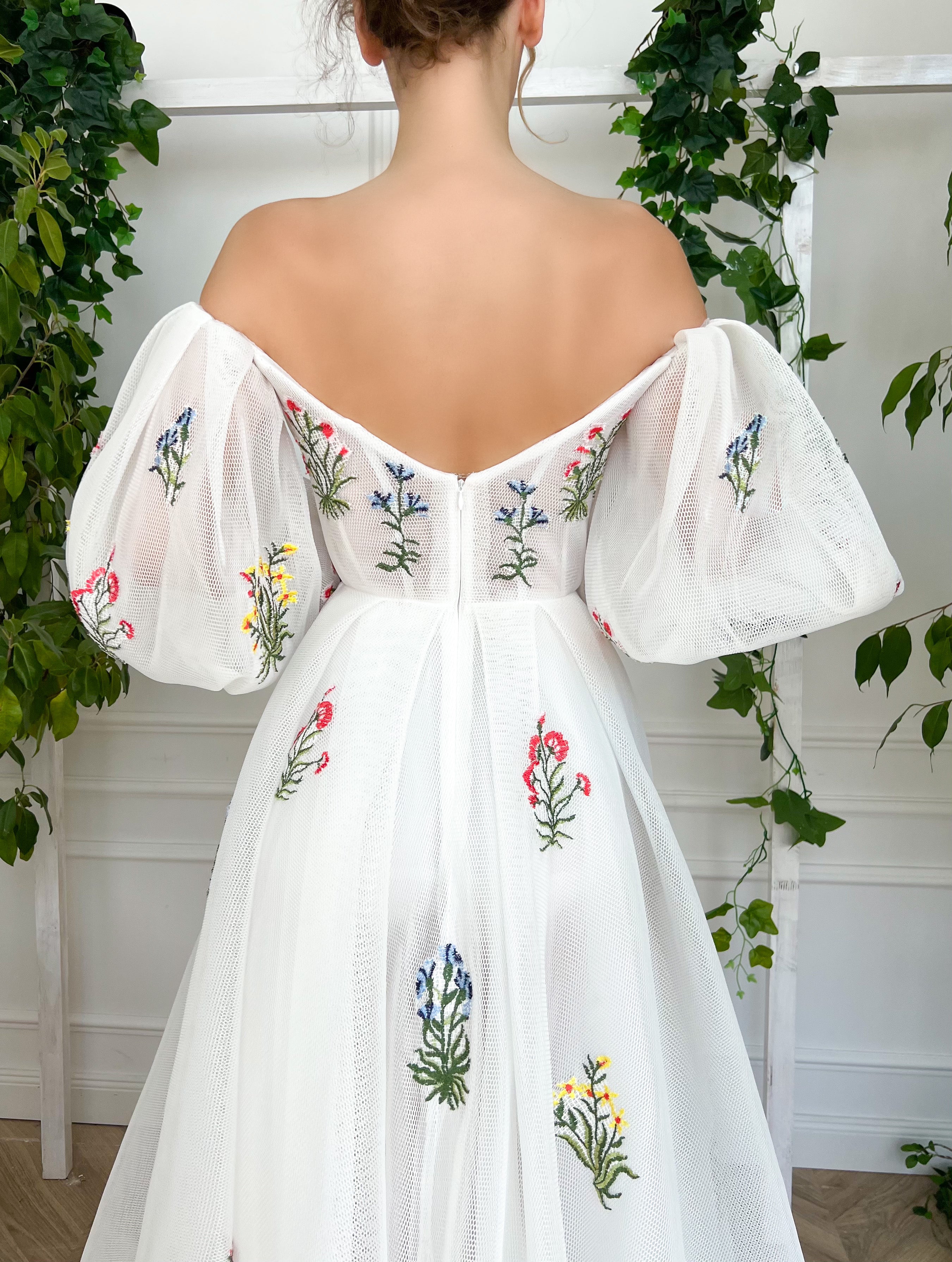 A line white bridal dress with embroidered flowers and off shoulder sleeves