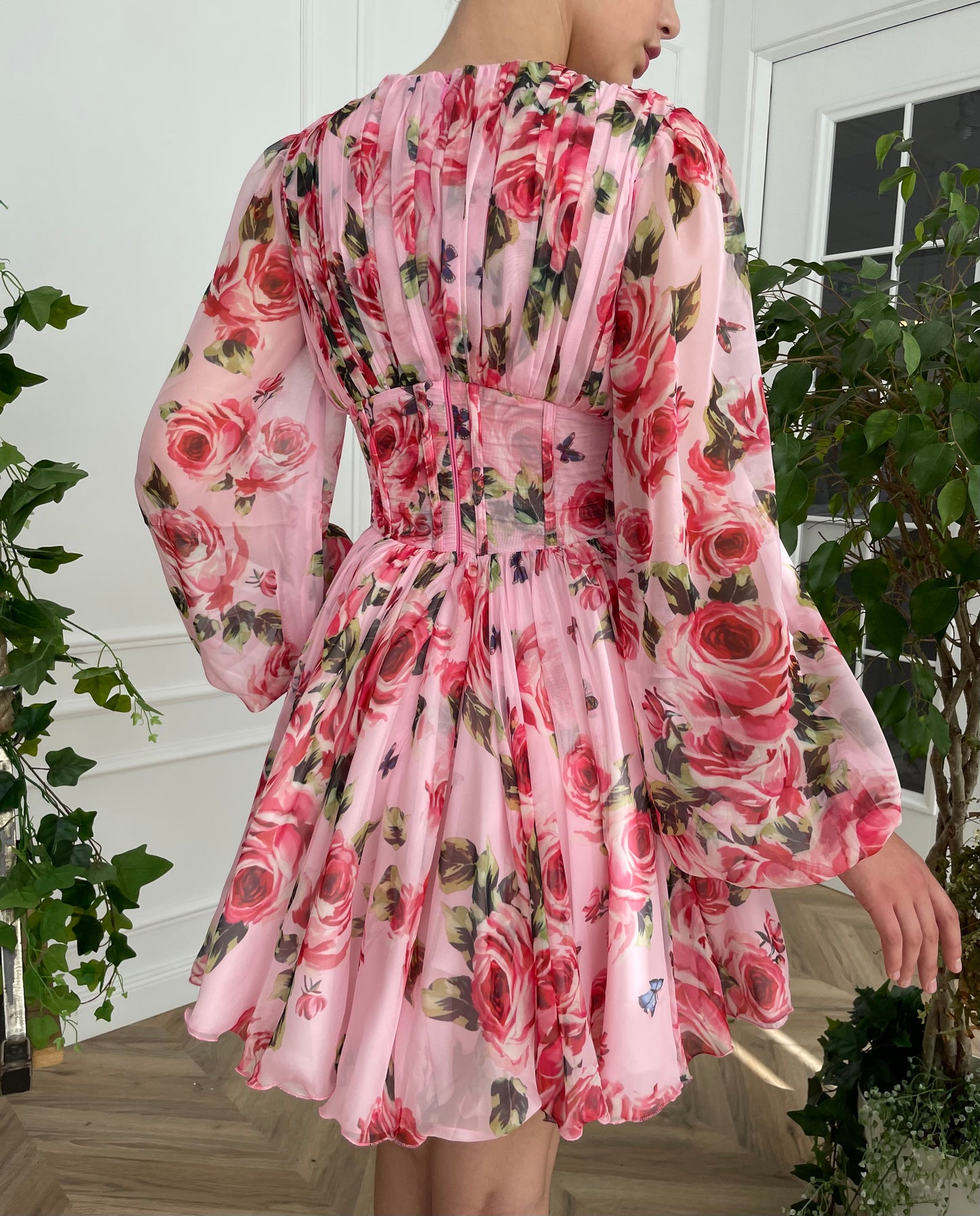 Pink mini dress with long sleeves and printed flowers