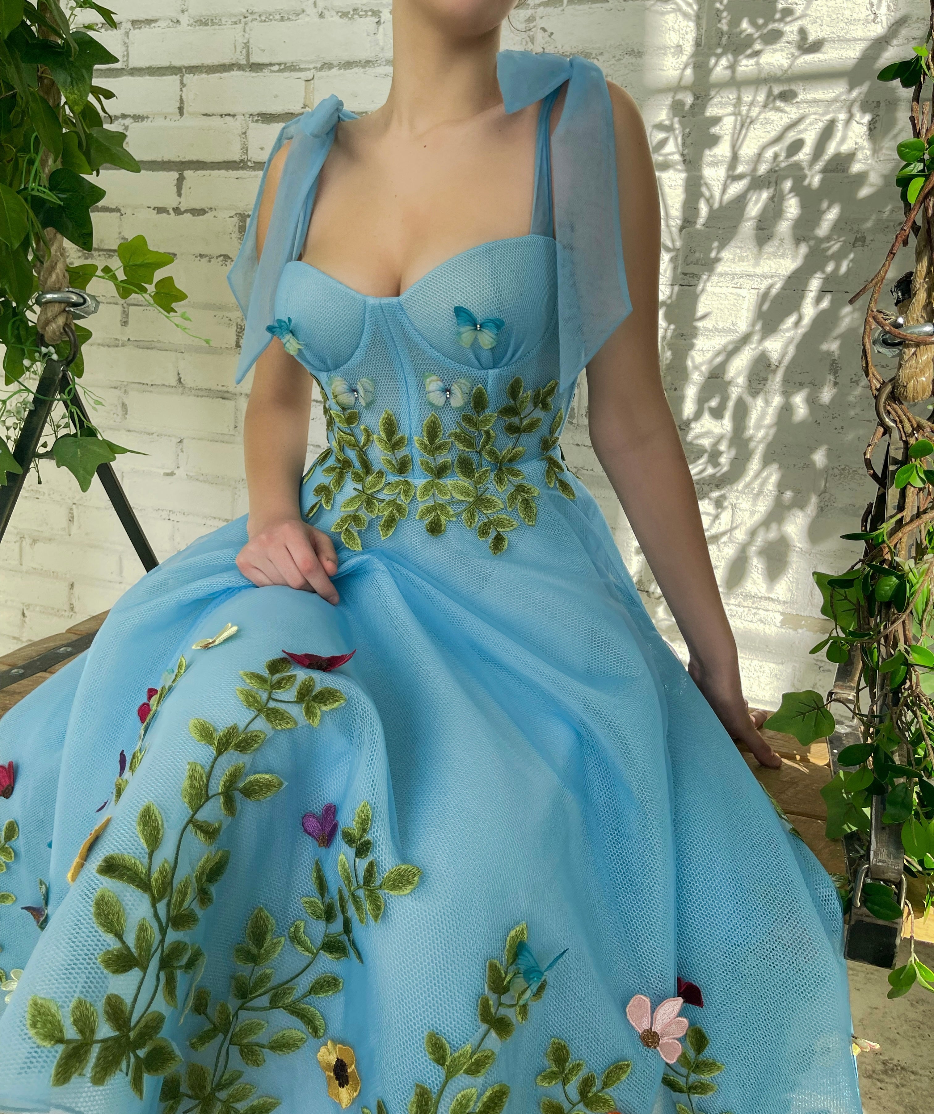 Blue midi dress with bow straps and embroidery