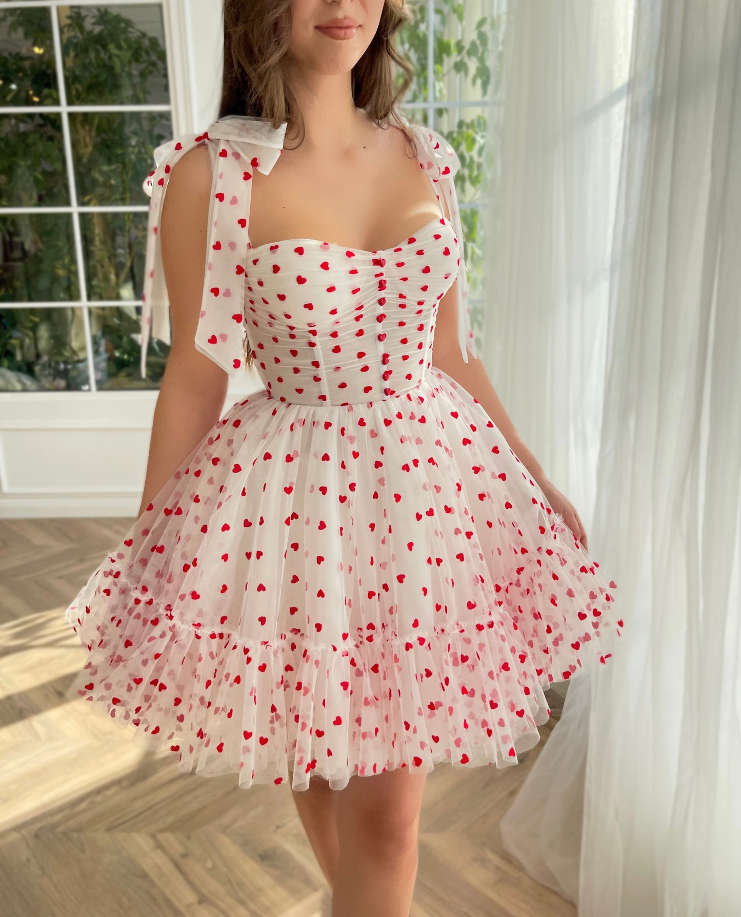 White mini dress with hearty print and bow straps