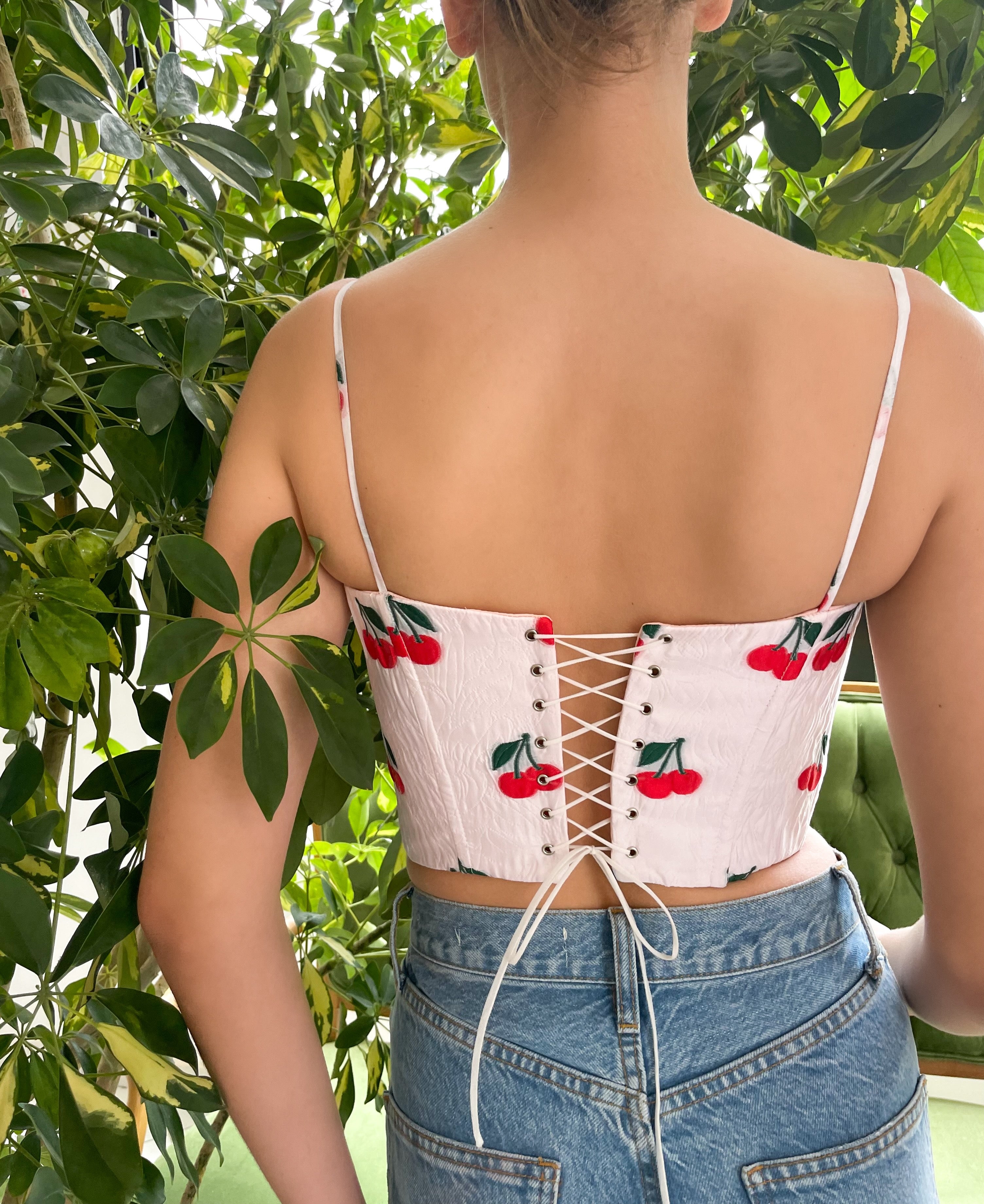 White corset with spaghetti straps and printed cherries