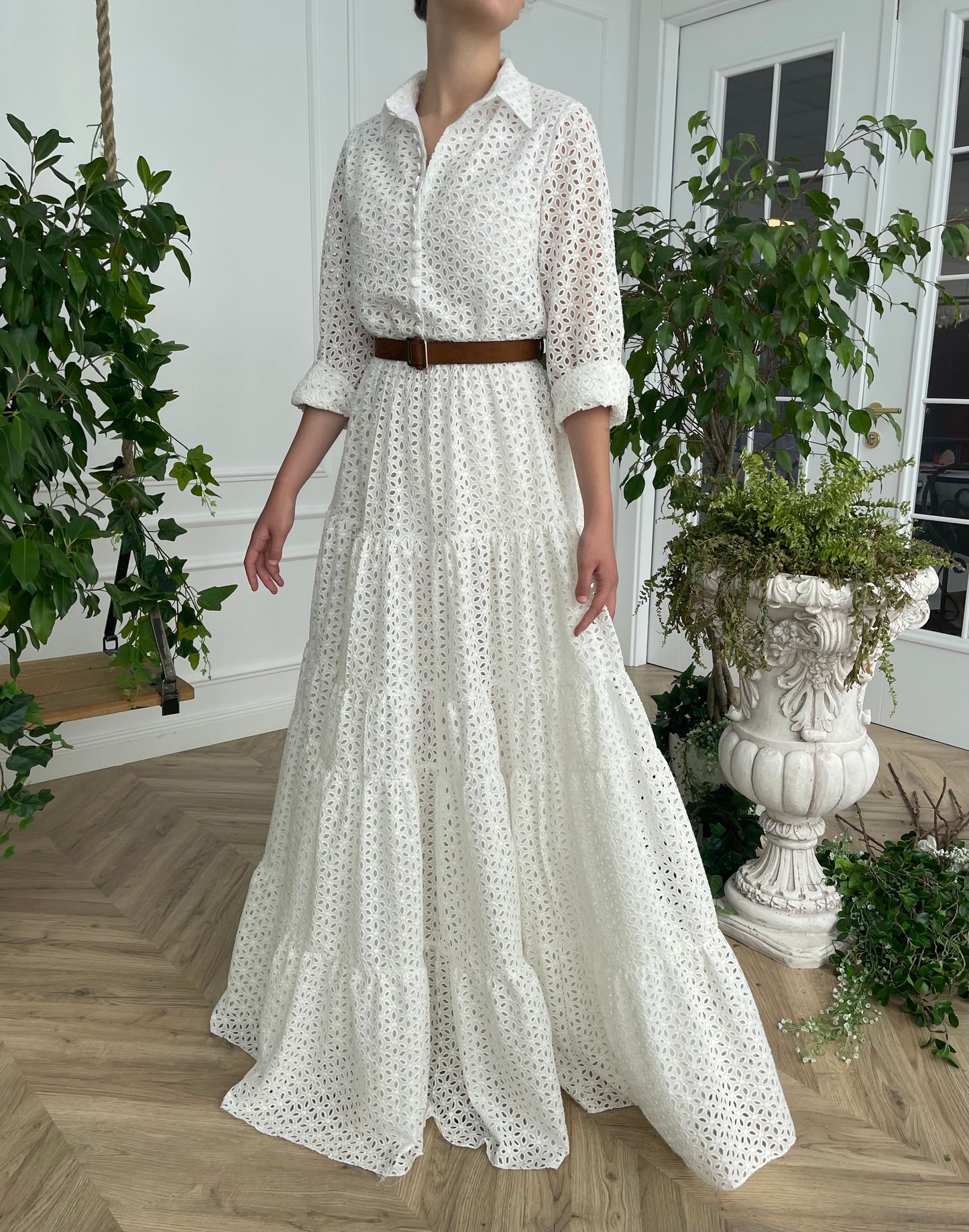 A line white bridal dress with brown belt and long sleeves